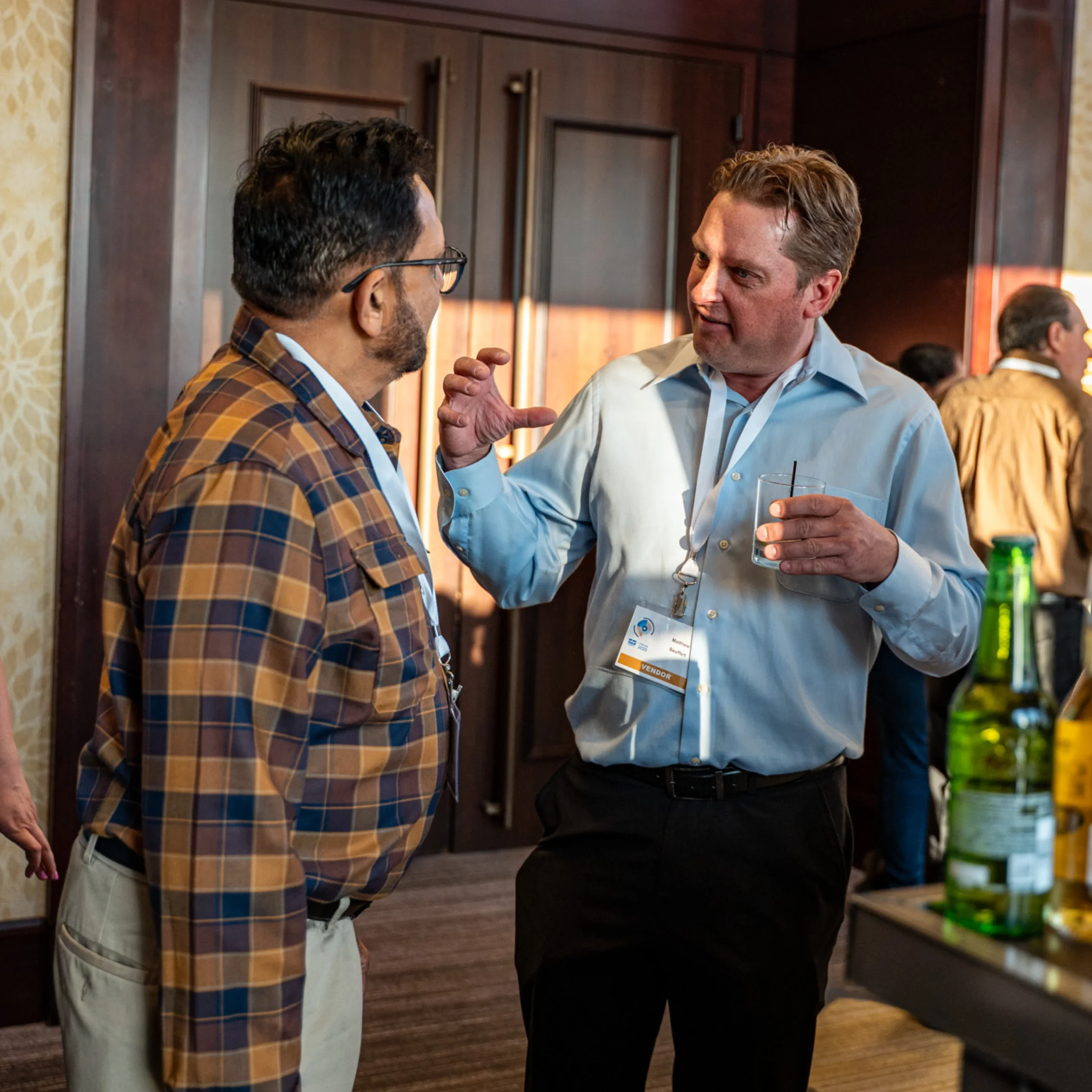 Two Vendors Talking at Bar