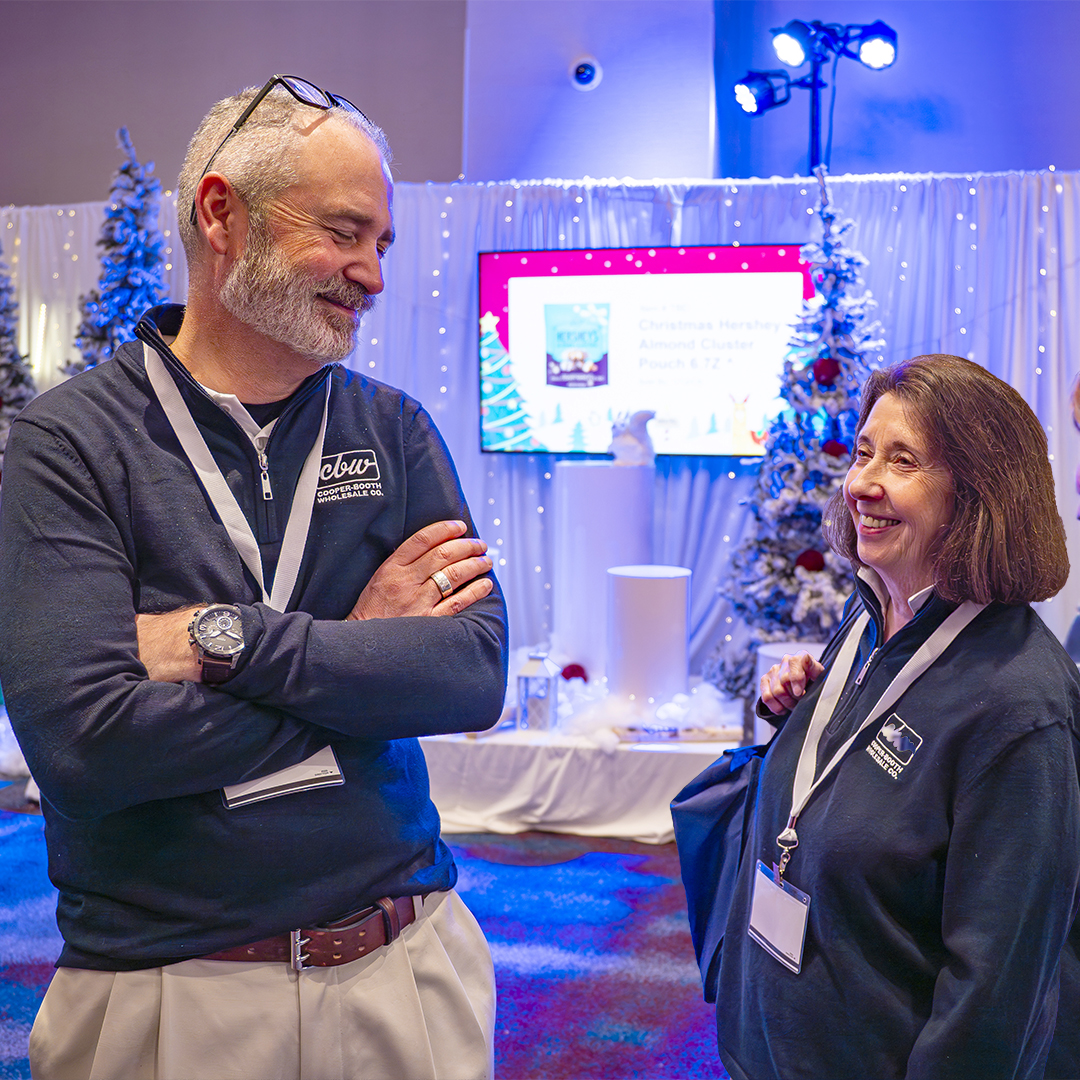 Jason and Phyllis Talk in Front of Christmas Booth