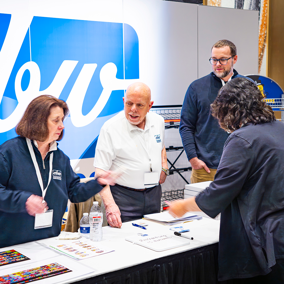 CBW Employees Help Customers at Merchandising Booth